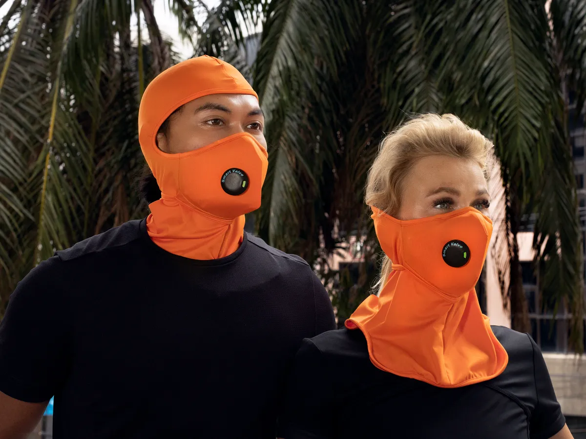 couple wearing penumbr and umbra pro masks in safety orange