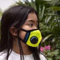 girl wearing a yellow styleseal pro face mask with smart valve