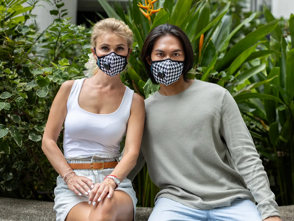 couple wearing penumbr and umbra pro masks in safety orange