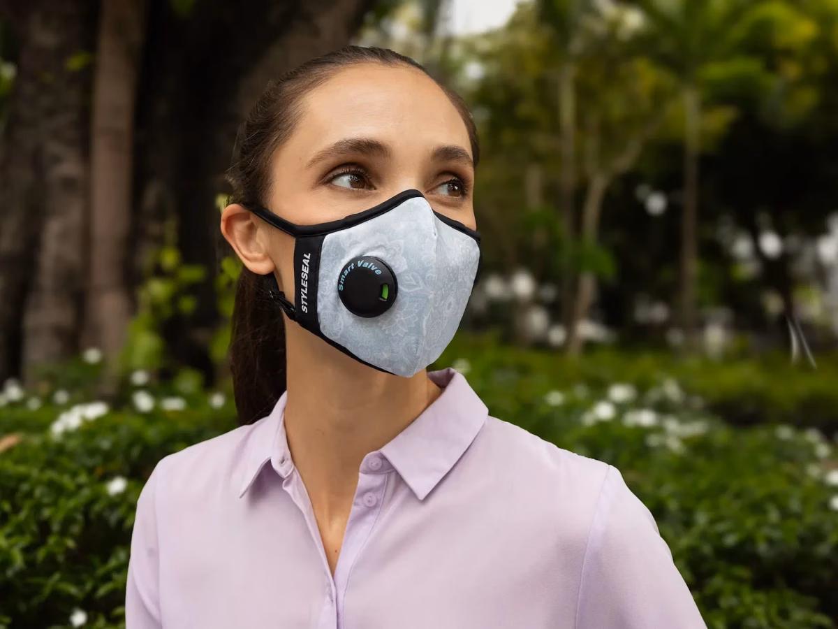 couple wearing penumbr and umbra pro masks in safety orange